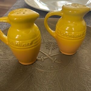 Le Creuset yellow ombre stoneware pitcher-shaped salt and pepper shaker set.